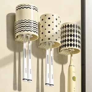 Portaspazzolino da parete color crema minimalista con tazze a motivi geometrici