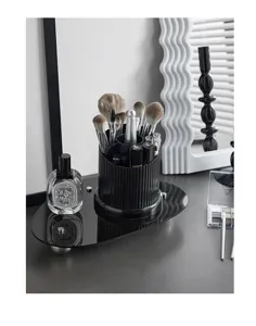 Gedetailleerd overzicht van een zwarte gecanneleerde make-up borstelhouder op bureau