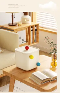 Minimalist cream desktop storage box with colorful spherical knobs on wooden table