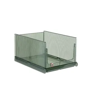 Stackable transparent green clothes storage bin with ribbed texture for wardrobe organization.