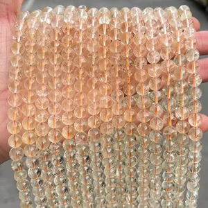 Close-up detail of 8mm natural citrine tower crystal round beads for DIY jewelry creations
