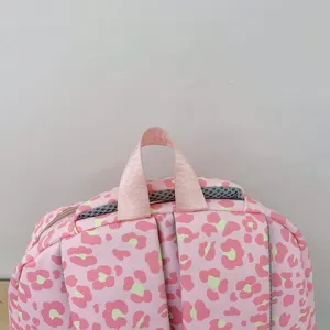 Close-up detail of pink leopard print backpack handle and breathable mesh straps