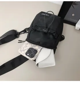 Detail view of black nylon crossbody bag showing interior storage capacity