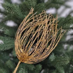 Close-up of golden glitter fireworks Christmas tree pick decoration with bokeh background