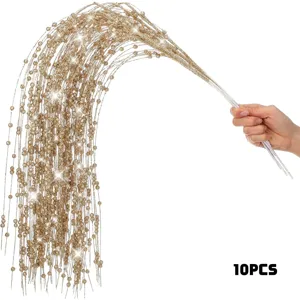 Close-up of 10 golden glitter willow branches being held for Christmas decoration
