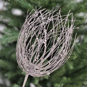 Close-up detail of a sparkling Christmas tree ornament branch with glitter fireworks