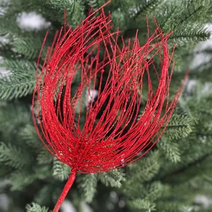Detailed view of a red glitter firework spray decoration for Christmas trees