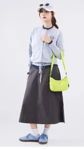 Detail of niche neon green nylon crossbody bag styled for a fashion commute look.