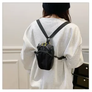Detail view of small outdoor tactical bag worn on back with adjustable straps