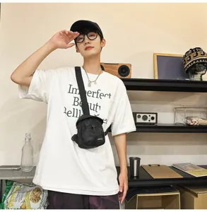 Stylish black camo chest bag for men worn by an Asian model in a modern indoor setting