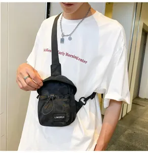 Close-up detailed view of stylish black nylon chest bag with adjustable strap on white tee