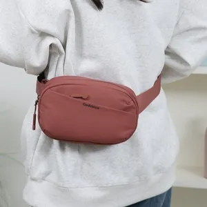Minimalist pink fanny pack for men and women worn as a trendy crossbody belt bag