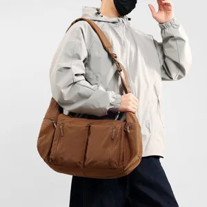 Large capacity brown waterproof nylon crossbody shoulder bag for men and women daily use.