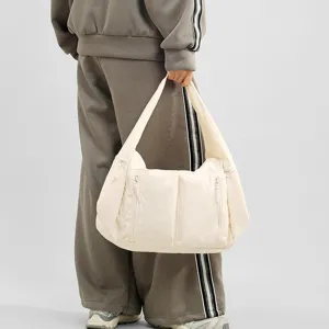Detail view of large capacity nylon shoulder bag with front zipper pockets for daily use style