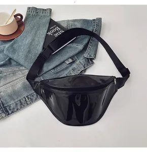 Minimalist black glossy chest bag detail, stylish crossbody waist bag with adjustable strap.