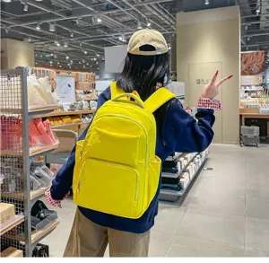 Detailed lifestyle view of the yellow casual backpack in a store, practical daily travel bag.