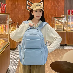 Casual light blue backpack with large capacity, multiple pockets, perfect for daily commute.