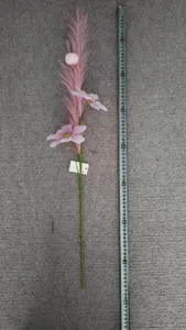 Detailed view of artificial pink cosmos flower branch with pampas grass and tape measure.