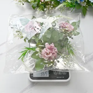 Artificial hydrangea flower bouquet in transparent bag on scale for home party decor.