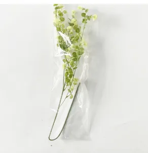 Detailansicht künstlicher grüner Pflanzenstiele mit kleinen Knospen in Plastikverpackung