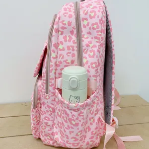 Side view of pink leopard print backpack showing the side pocket with a water bottle