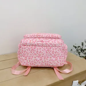 Detailed back view of a pink leopard print large capacity backpack on a neutral base