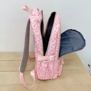Side view of pink leopard print backpack with open compartments showing interior lining