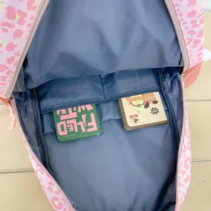 Internal compartment view of the pink leopard backpack with two functional slip pockets
