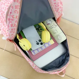 Interior view of pink leopard print backpack with large storage capacity for laptop and books.