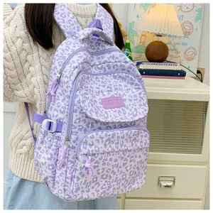 Close-up of a student wearing a stylish purple leopard print backpack with multiple pockets