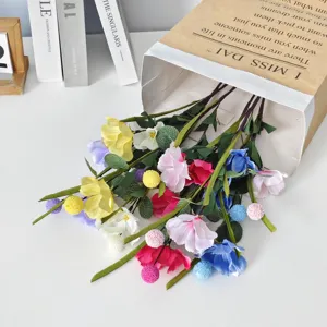 Detailed shot of multi-colored simulation poppy flowers spilling from a paper bag