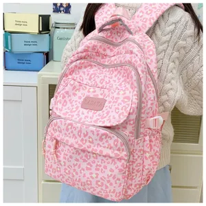 Macro view of stylish pink leopard print backpack with detailed stitching and logo