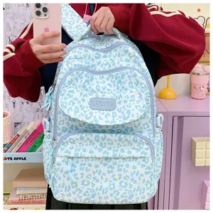 Close-up of a student carrying the stylish light blue leopard print large capacity backpack