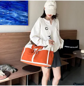 Large orange sports travel bag with wet dry separation for gym and outdoor fitness.