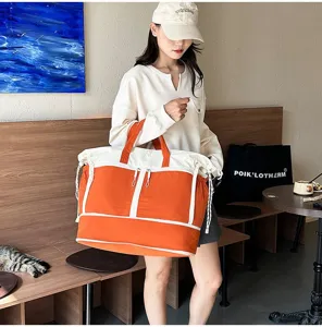 Large orange travel bag with wet and dry separation for outdoor sports and gym use.