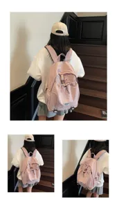 Rear view of a stylish pink student backpack with drawstring front pocket detail