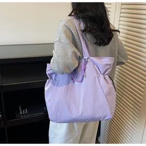 Close-up of large purple waterproof nylon tote bag used for travel and commuting