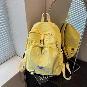 Fashionable yellow large capacity school backpack for students with drawstring front pocket