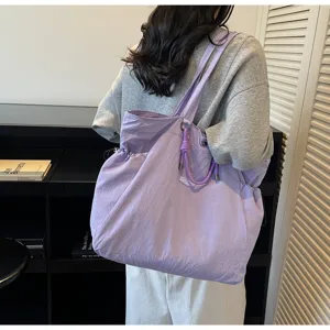 Detailed view of a large purple waterproof tote bag for travel and commuting.
