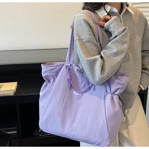 Close-up of a stylish large purple waterproof shoulder bag for travel and daily commuting