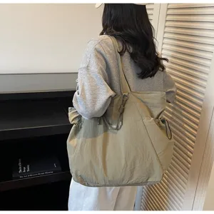 Back view of a large olive waterproof travel tote bag for commuting and vacations