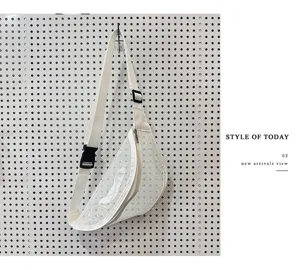 Transparent PVC chest bag detail showing white trim, black buckle strap and clean design.