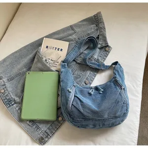 Detailed view of the vintage denim hobo bag with zip pockets and pleated design