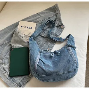 Detailed close-up view of a retro large capacity denim dumpling bag with multiple zippers