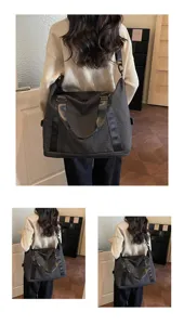 Large capacity dark plaid travel duffel bag shown worn crossbody by a woman in an interior