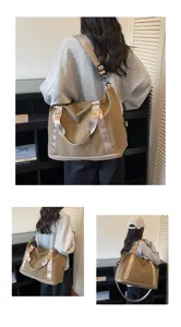 Large capacity checkered travel duffel bag shown from multiple angles on a model