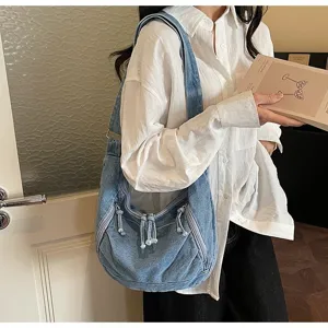 Large capacity vintage blue denim hobo bag with zipper details and tassels worn by model