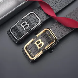 Detail view of men's crocodile embossed leather belts with gold and silver letter B buckles