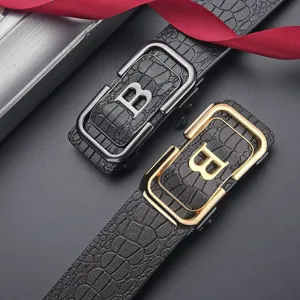 Detail shot of men's leather belt with crocodile pattern and gold/silver B buckle