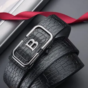 Detailed close-up of a black crocodile pattern leather belt with a metallic B buckle